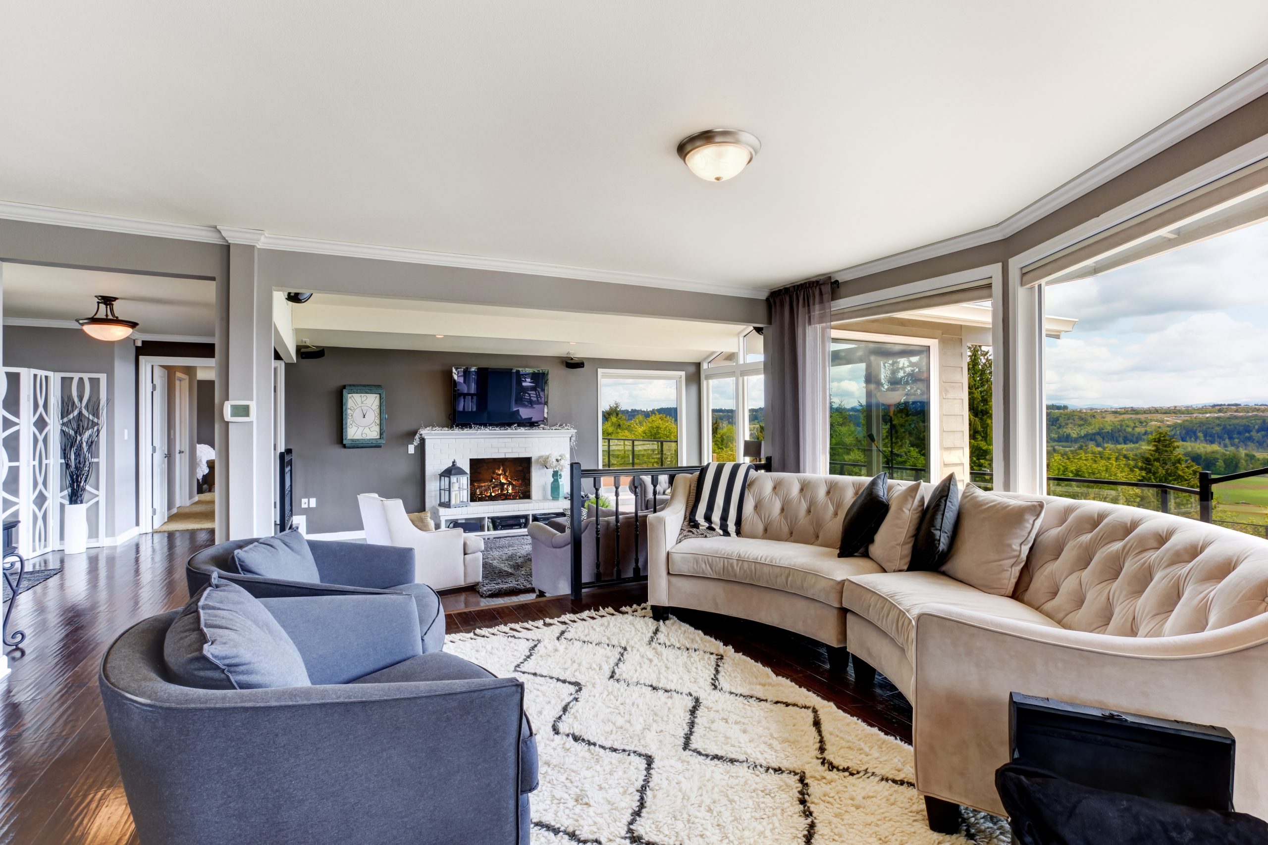 Elegant living room interior in luxury house Bright elegant living room interior with white and lavender furniture, fireplace and tv
